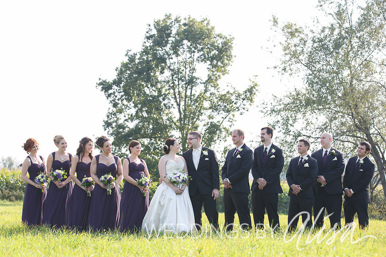 Bridal party photos on sunny day in field