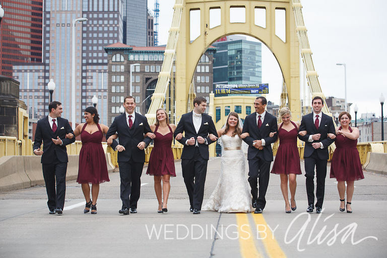 Wedding party walks on yellow bridge in Pittsburgh for wedding photos