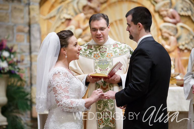 Bride and grooms saying vows at Catholic wedding in Pittsurgh