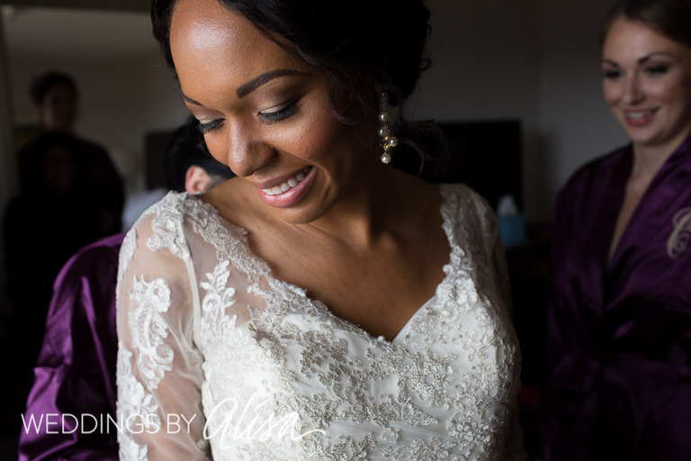 Black bride getting dressed for Wedding at Phipps