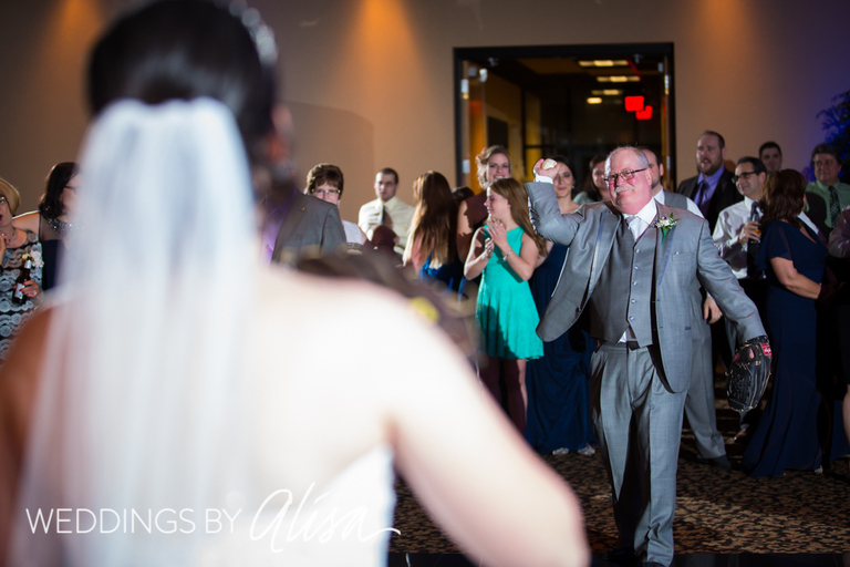 Bride playing catch with Dad on dance floor at reception