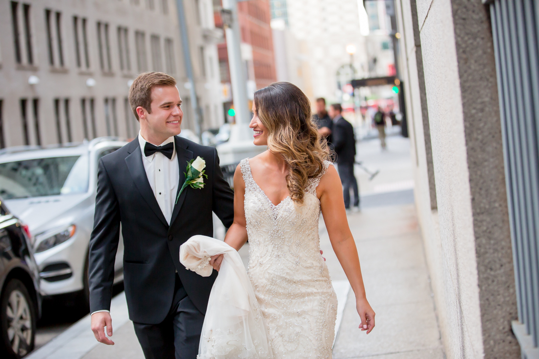 Bride and Groom walking by Hotel Monaco